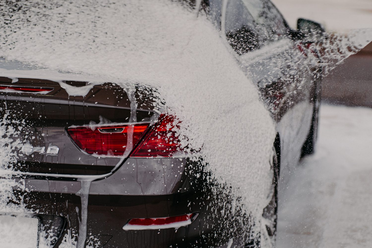 Cleaning car using soap and water pressure. Automobile wash. Transportation washed at local car wash. Vehicle concept. Washing service