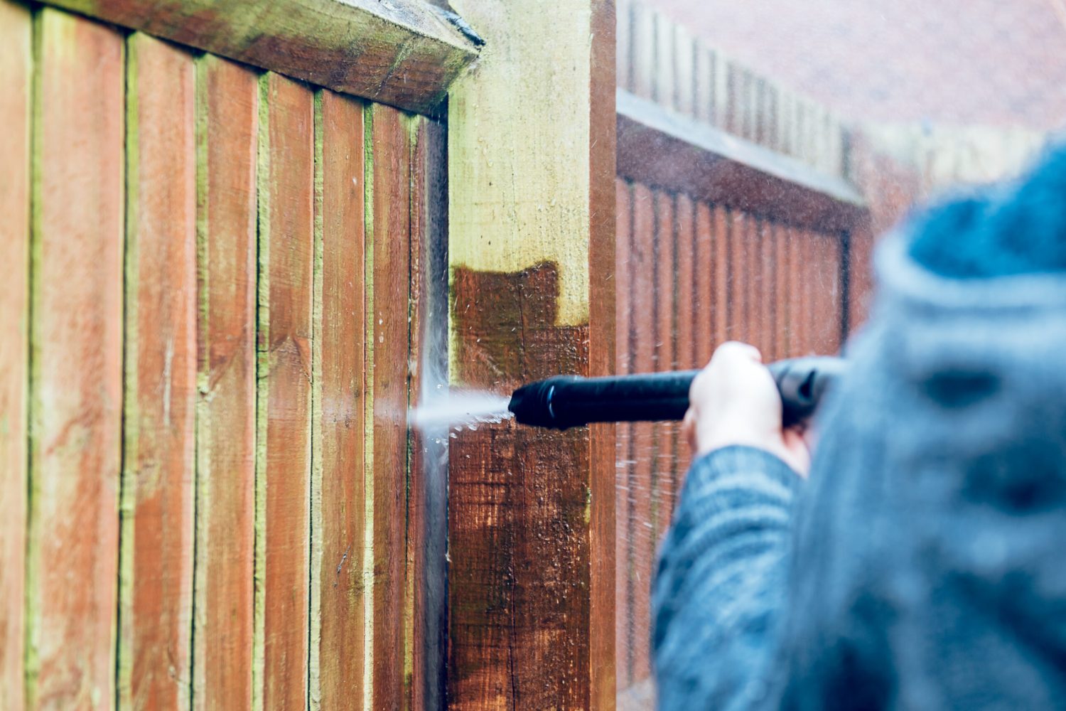 Cleaning and Renovating Wood Fence with powerful jet wash or pressure washer, spring cleaning of the garden and house